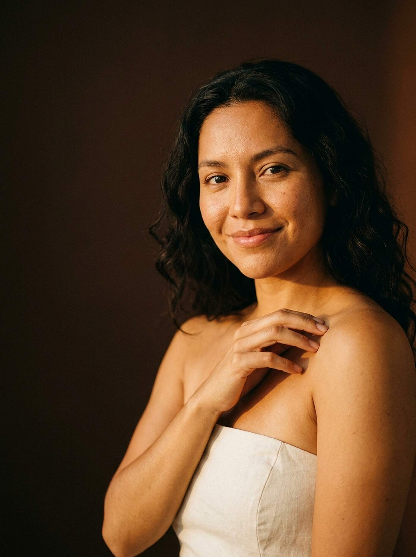 Latina woman with warm brown skin, smooth skin